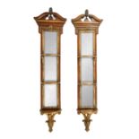 A PAIR OF REPRODUCTION GEORGE II STYLE PARCEL GILT AND WALNUT HANGING MIRRORS