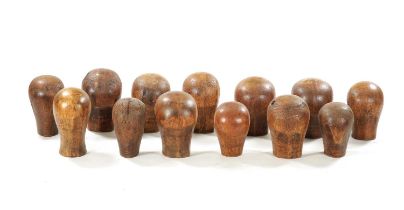 A COLLECTION OF THIRTEEN 19TH CENTURY WOODEN WIG STANDS