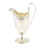 A GEORGE III HELMET STYLE SILVER CREAM JUG