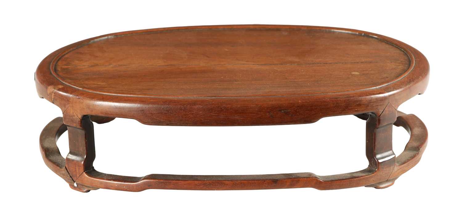 A 19TH CENTURY CHINESE HARDWOOD OVAL SHAPED JARDINIERE STAND