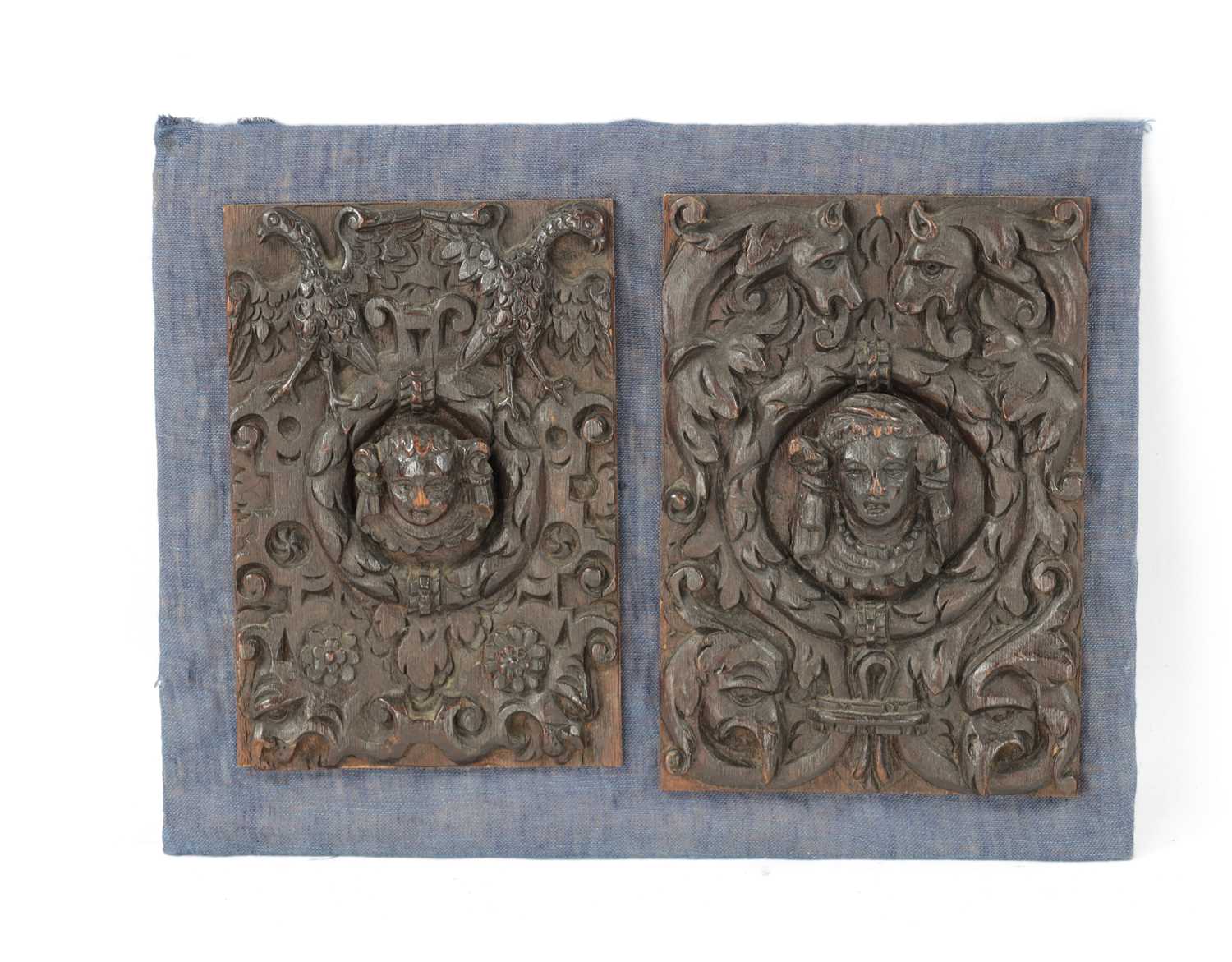TWO 17TH CENTURY CARVED OAK MASKED PANELS