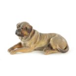 A 19TH CENTURY AUSTRIAN PAINTED TERRACOTTA SCULPTURE OF A RECUMBENT MASTIFF