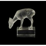A LALIQUE CLEAR GLASS PAPERWEIGHT OF A DEER