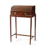 A REGENCY MAHOGANY TAMBOUR FRONT WRITING TABLE ON STAND