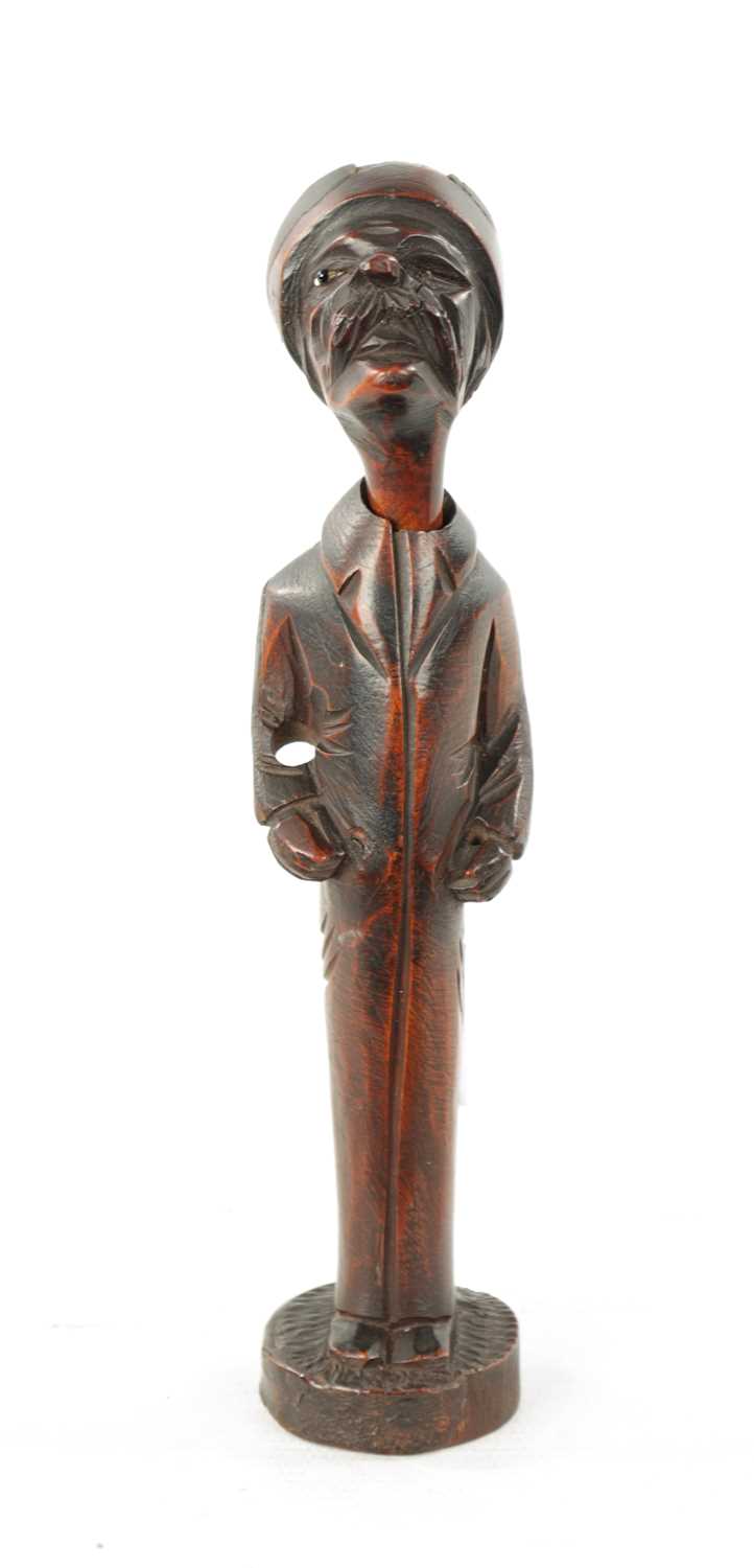 A 19TH CENTURY CONTINENTAL CARVED FRUITWOOD FIGURAL PIPE AND STAND