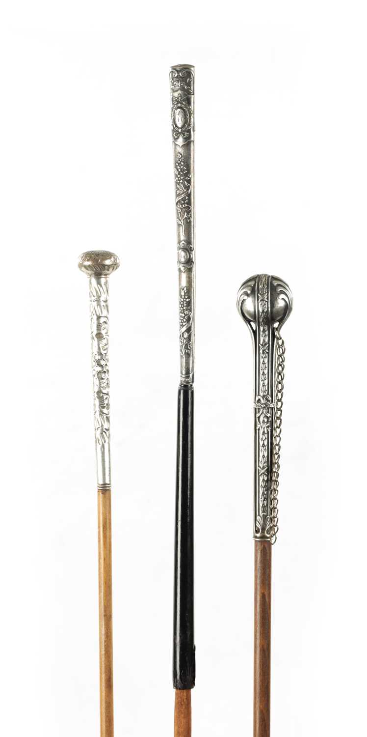 A COLLECTION OF THREE LATE 19TH CENTURY SILVER TOPPED LONG-HANDLED WALKING STICKS