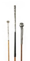 A COLLECTION OF THREE LATE 19TH CENTURY SILVER TOPPED LONG-HANDLED WALKING STICKS