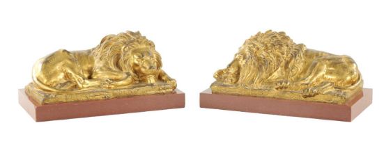 A PAIR OF LATE 19TH CENTURY GILT BRONZE RECUMBENT LIONS