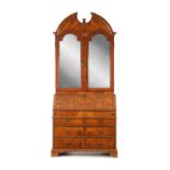 AN EARLY 18TH CENTURY FIGURED WALNUT AND OAK BREAK ARCHED TOP BUREAU BOOKCASE