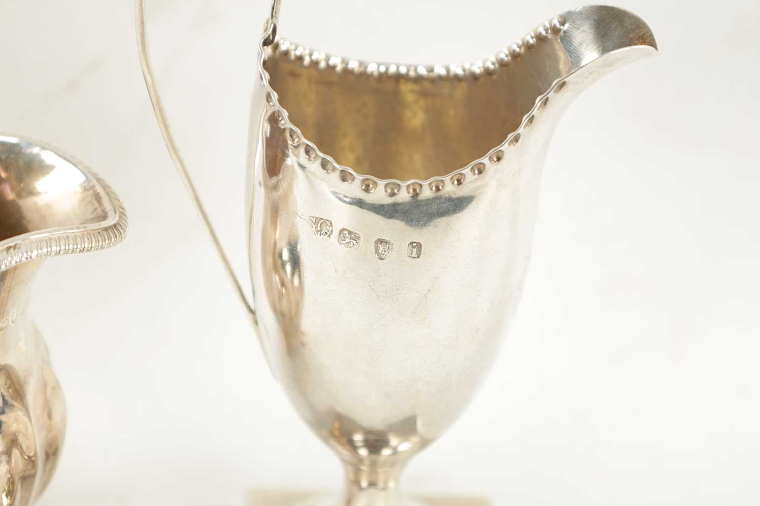 A GEORGE III HELMET CREAM JUG AND MILK JUG - Image 5 of 5