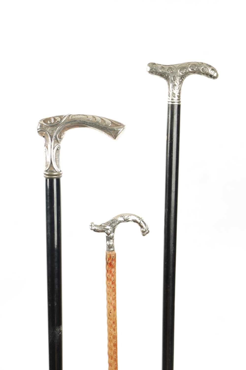 A COLLECTION OF THREE LATE 19TH CENTURY ART NOUVEAU SILVER TOPPED WALKING STICKS