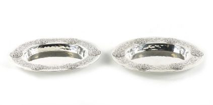 A PAIR OF LIBERTY & CO. ARTS AND CRAFTS SILVER OVAL DISHES DESIGNED BY BERNARD CUZNER