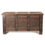 A 17TH CENTURY CARVED OAK THREE PANELLED FRONT COFFER