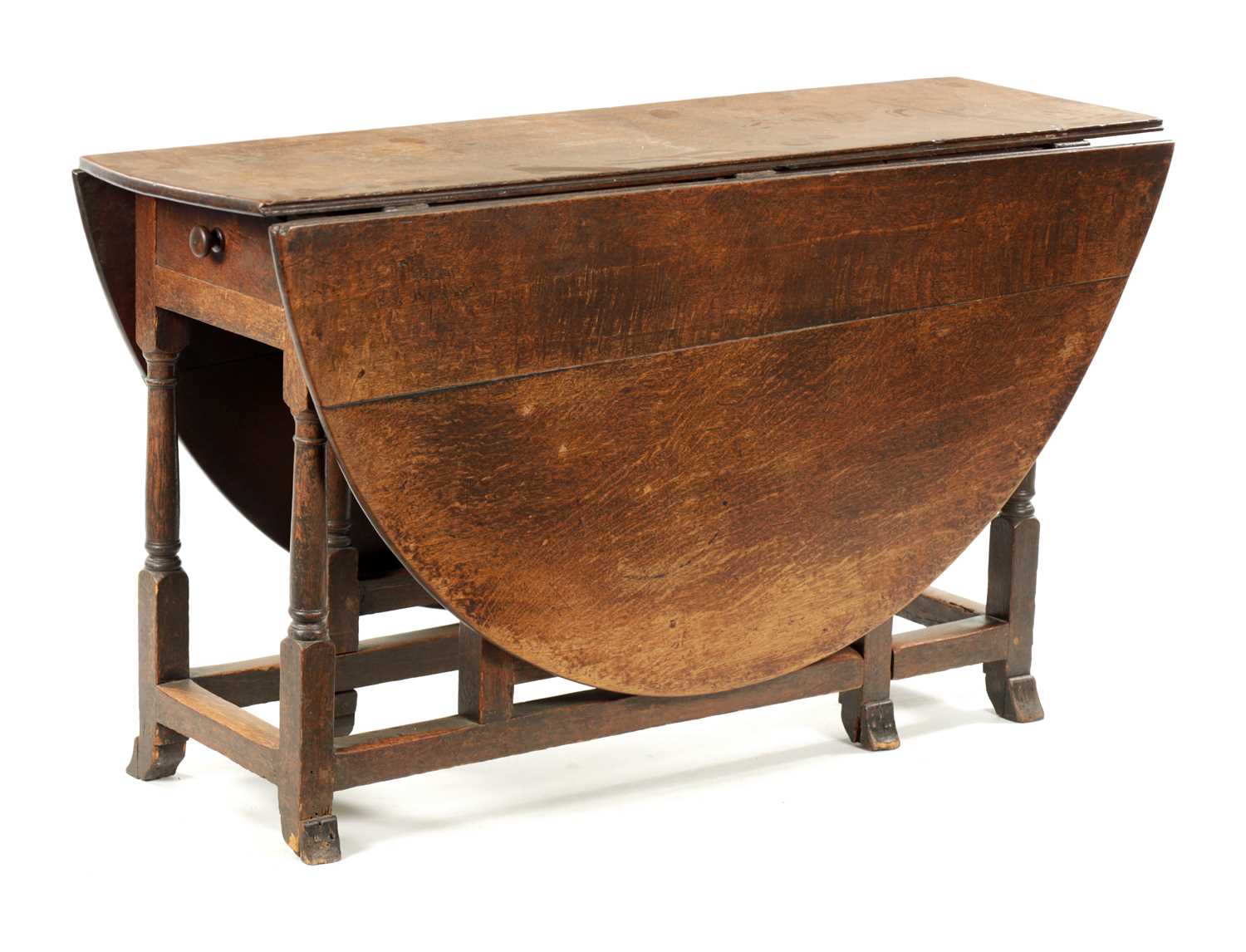 A LATE 17TH CENTURY OAK GATELEG TABLE WITH BREGANZA FEET