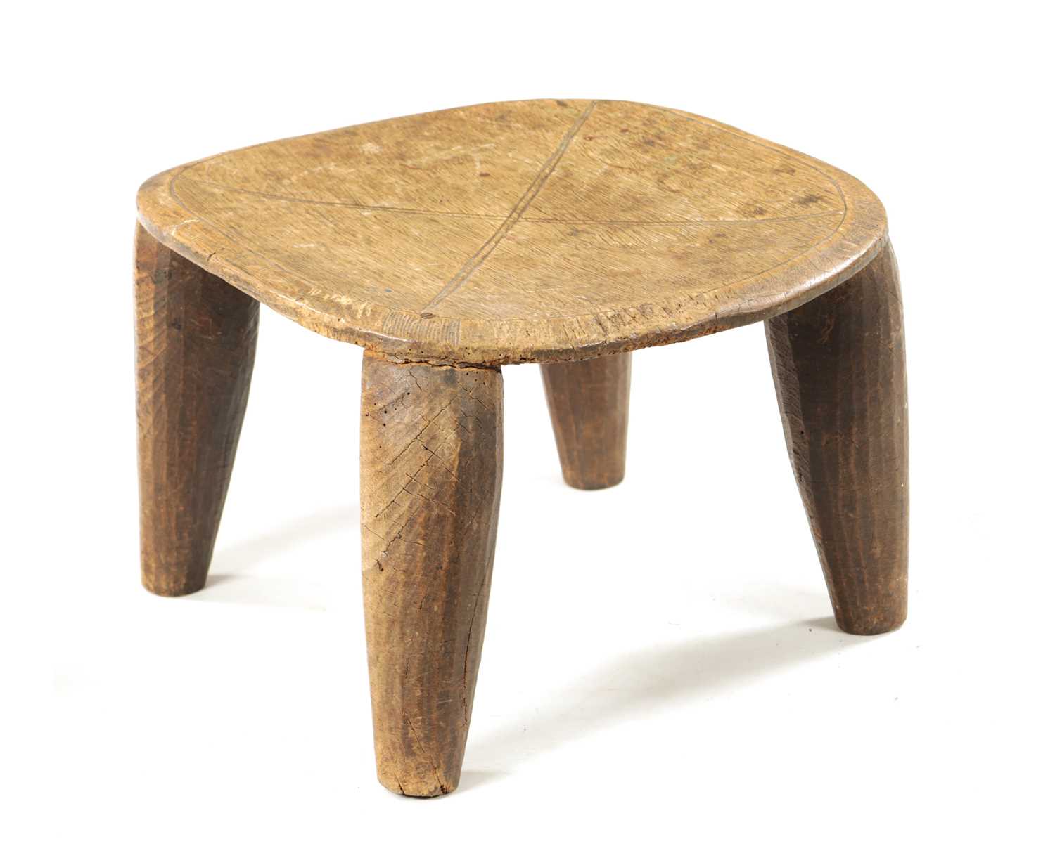 AN ANTIQUE NATIVE HARDWOOD FOUR-LEG STOOL