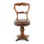 A 19TH CENTURY ROSEWOOD REVOLVING MUSIC CHAIR