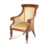 A GOOD WILLIAM V CARVED MAHOGANY BERGERE LIBRARY CHAIR WITH OLD LANCASTER PAPER LABEL - POSSIBLY GIL