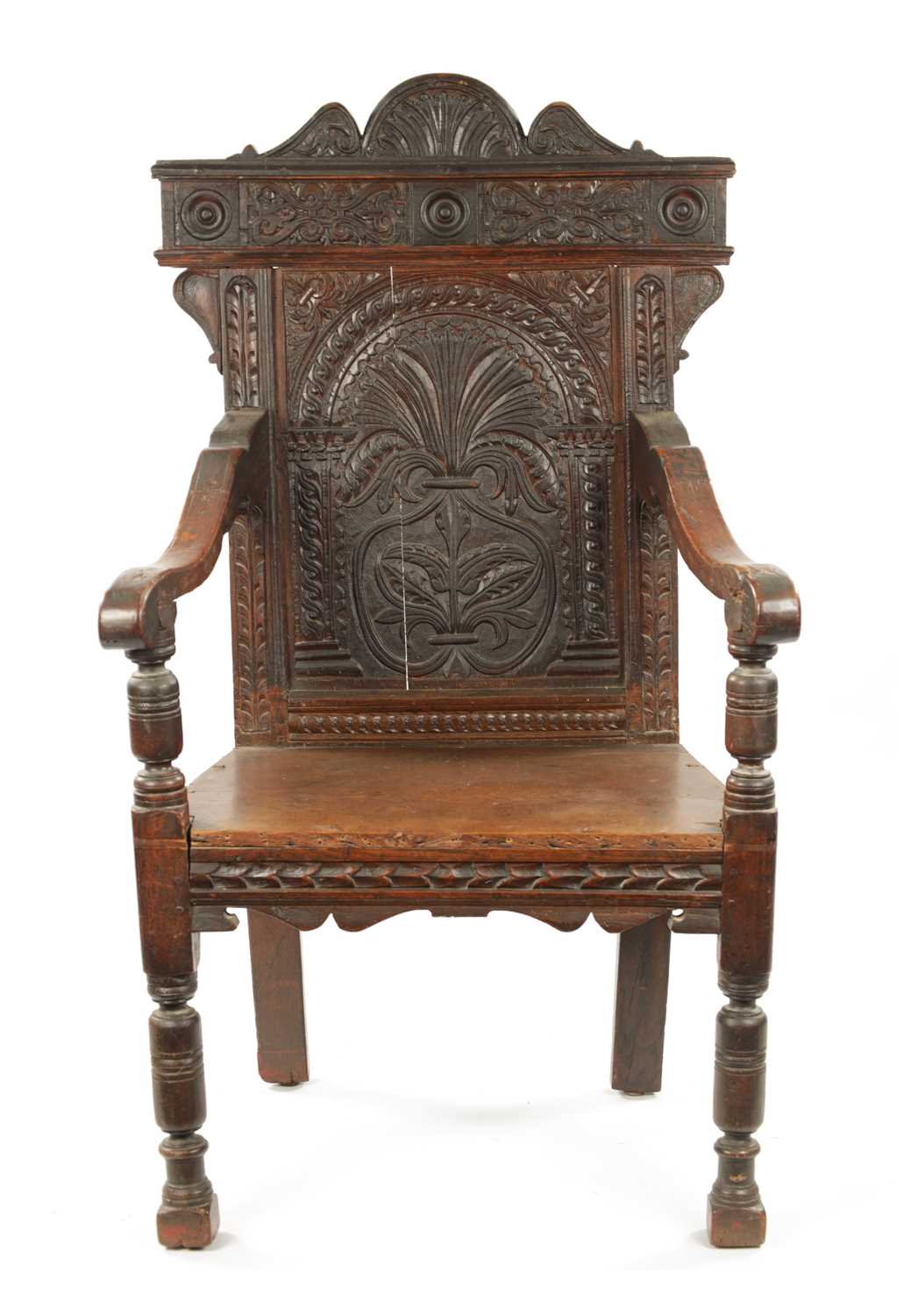 A 17TH CENTURY CARVED OAK WAINSCOT CHAIR