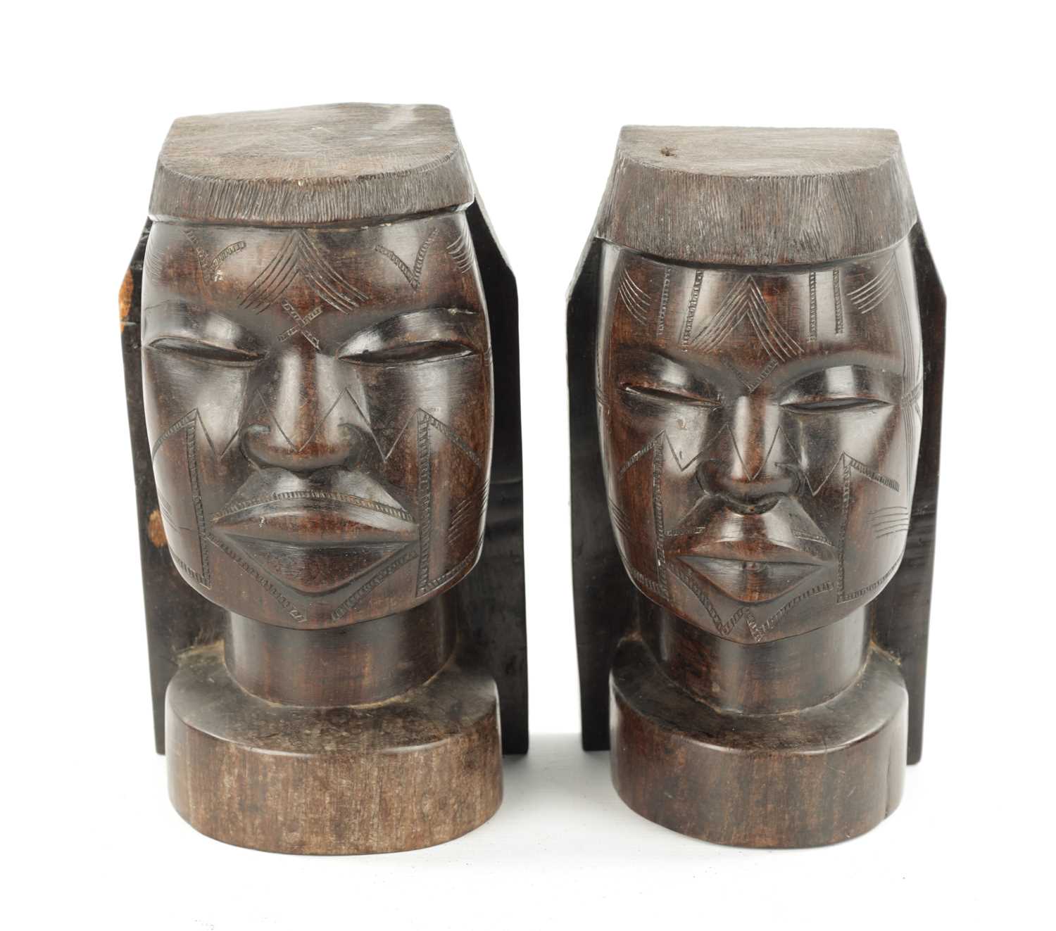 A PAIR OF CARVED HARDWOOD NATIVE BOOKENDS