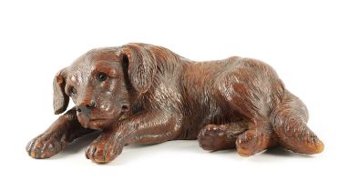 A 19TH CENTURY BLACK FOREST CARVED LINDEN WOOD DOG SCULPTURE