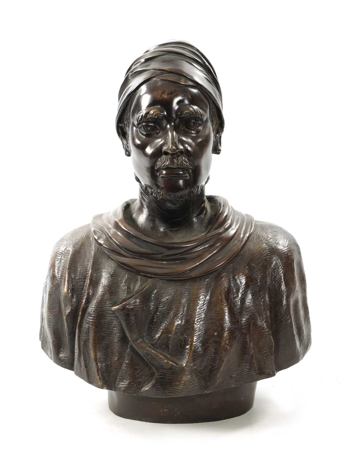 A LIFE SIZE PATINATED BRONZE BUST OF TURK