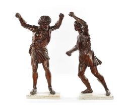 A PAIR OF GRAND TOUR CARVED WALNUT GLADIATORS AFTER THE BORGHESE BRONZE ROMAN FIGURES