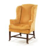 A GEORGE III STYLE MAHOGANY WING BACK UPHOLSTERED ARMCHAIR