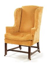 A GEORGE III STYLE MAHOGANY WING BACK UPHOLSTERED ARMCHAIR