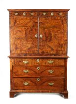 A WILLIAM AND MARY CROSS-BANDED AND GEOMETRICALLY INLAID FIGURED WALNUT CABINET ON CHEST