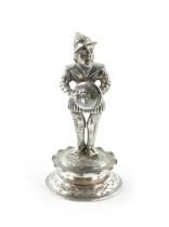 A MINIATURE SILVER FIGURE OF A MUSICIAN