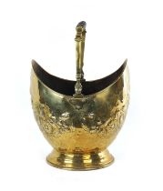 A 19TH CENTURY FRENCH FLORALLY EMBOSSED DOUBLE-SIDED BRASS COAL BUCKET