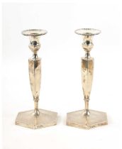 A PAIR OF SILVER CANDLESTICKS