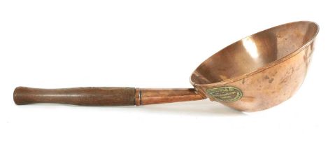 AN 19TH CENTURY COPPER SCOOP OF UNUSUALLY LARGE SIZE