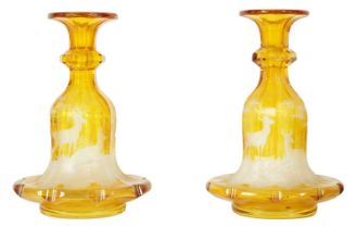 A FINE PAIR OF 19TH CENTURY BOHEMIAN AMBER FLASHED GLASS DECANTERS