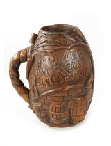 A LARGE LATE 19TH CENTURY GERMAN CARVED WOOD ALE JUG