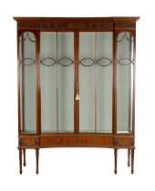 AN EARLY 20TH CENTURY MAHOGANY CONCAVE FRONT DISPLAY CABINET