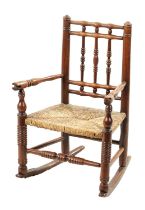 A 19TH CENTURY FRUITWOOD CHILDS ROCKING CHAIR