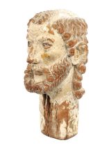 A 17TH CENTURY CARVED WOODEN POLYCHROME DECORATED HEAD POSSIBLY OF JOHN THE BAPTIST IN THE MANNER OF