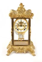 A 19TH CENTURY ROCOCO STYLE CASED FRENCH FOUR GLASS MANTEL CLOCK