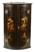 A GEORGE III BLACK LACQUER AND CHINOISERIE HANGING BOWFRONT CORNER CUPBOARD