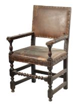 AN EARLY JOINED OAK LEATHER UPHOLSTERED ARMCHAIR