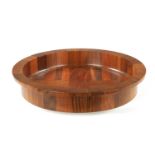 A CIRCULAR CONTEMPORARY SEGMENTED HARDWOOD BOWL BY COCOBOLO, DENMARK