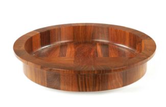 A CIRCULAR CONTEMPORARY SEGMENTED HARDWOOD BOWL BY COCOBOLO, DENMARK