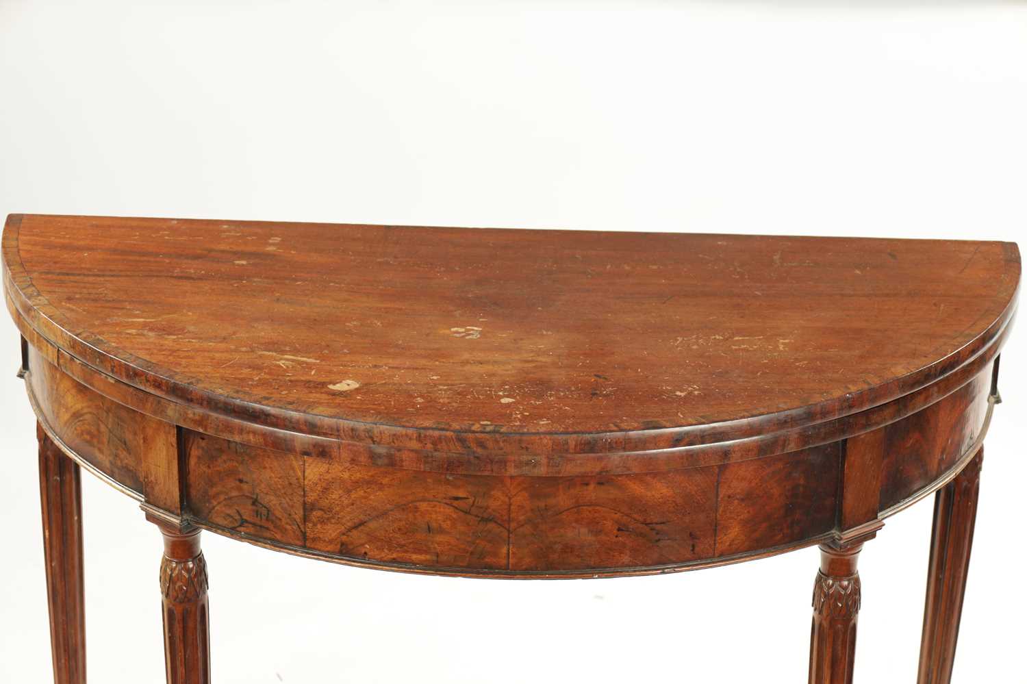 A LATE 18TH CENTURY DEMI LUNE CARD TABLE ON FLUTED LEGS IN THE MANNER OF GILLOWS - Image 3 of 7