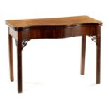 A FINE OVERSIZED GEROGE III SERPENTINE MAHOGANY TEA-TABLE IN THE MANNER OF THOMAS CHIPPENDALE
