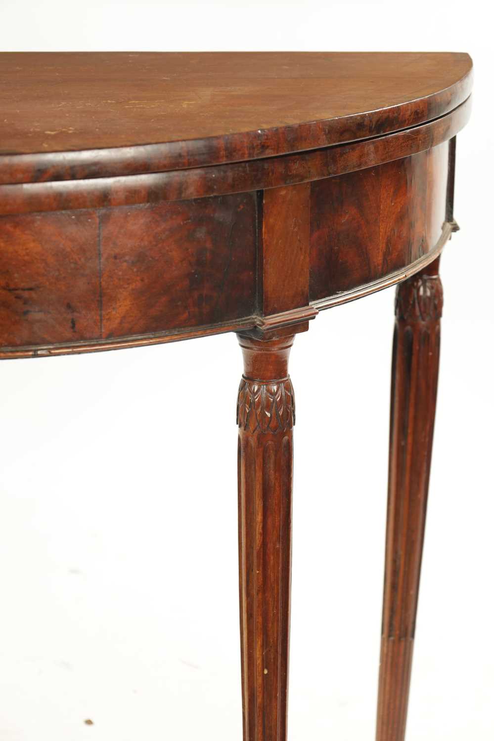 A LATE 18TH CENTURY DEMI LUNE CARD TABLE ON FLUTED LEGS IN THE MANNER OF GILLOWS - Image 4 of 7