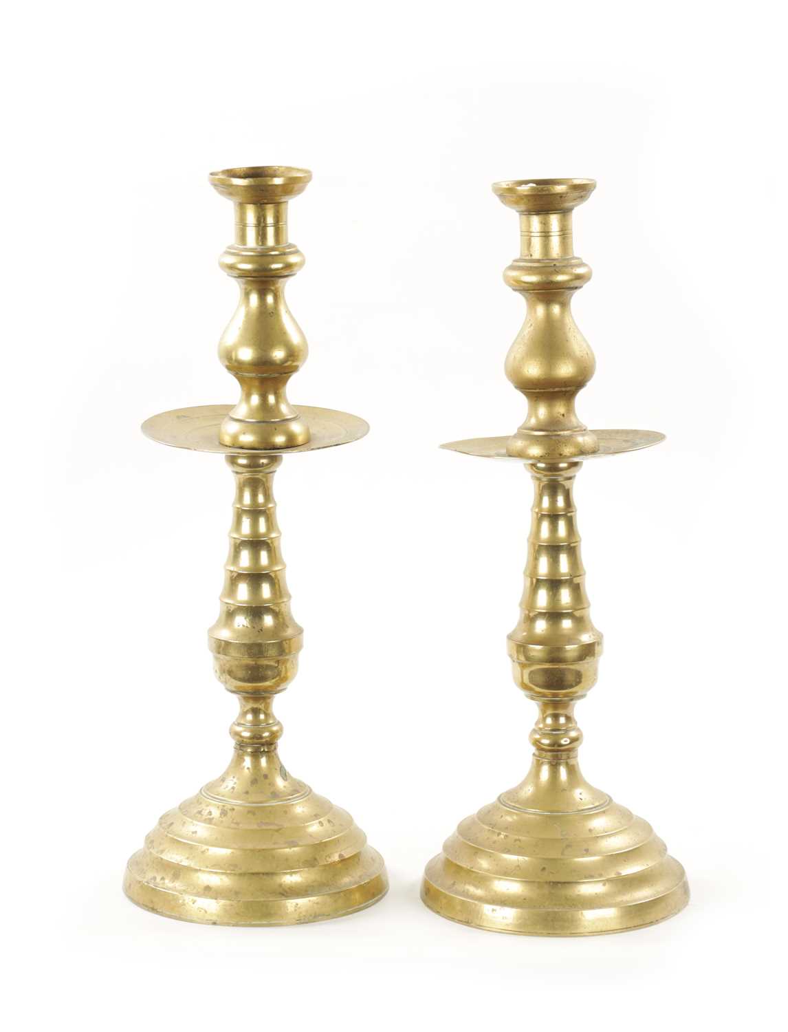 A LARGE PAIR OF 18TH CENTURY BRASS CANDLESTICKS