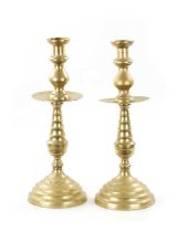 A LARGE PAIR OF 18TH CENTURY BRASS CANDLESTICKS