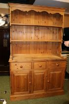 Pine dresser with cupboard base over drawers and shelf back