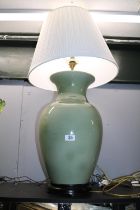 Large Chinese celadon glaze lamp with brass fittings on hardwood base, with classical pleated